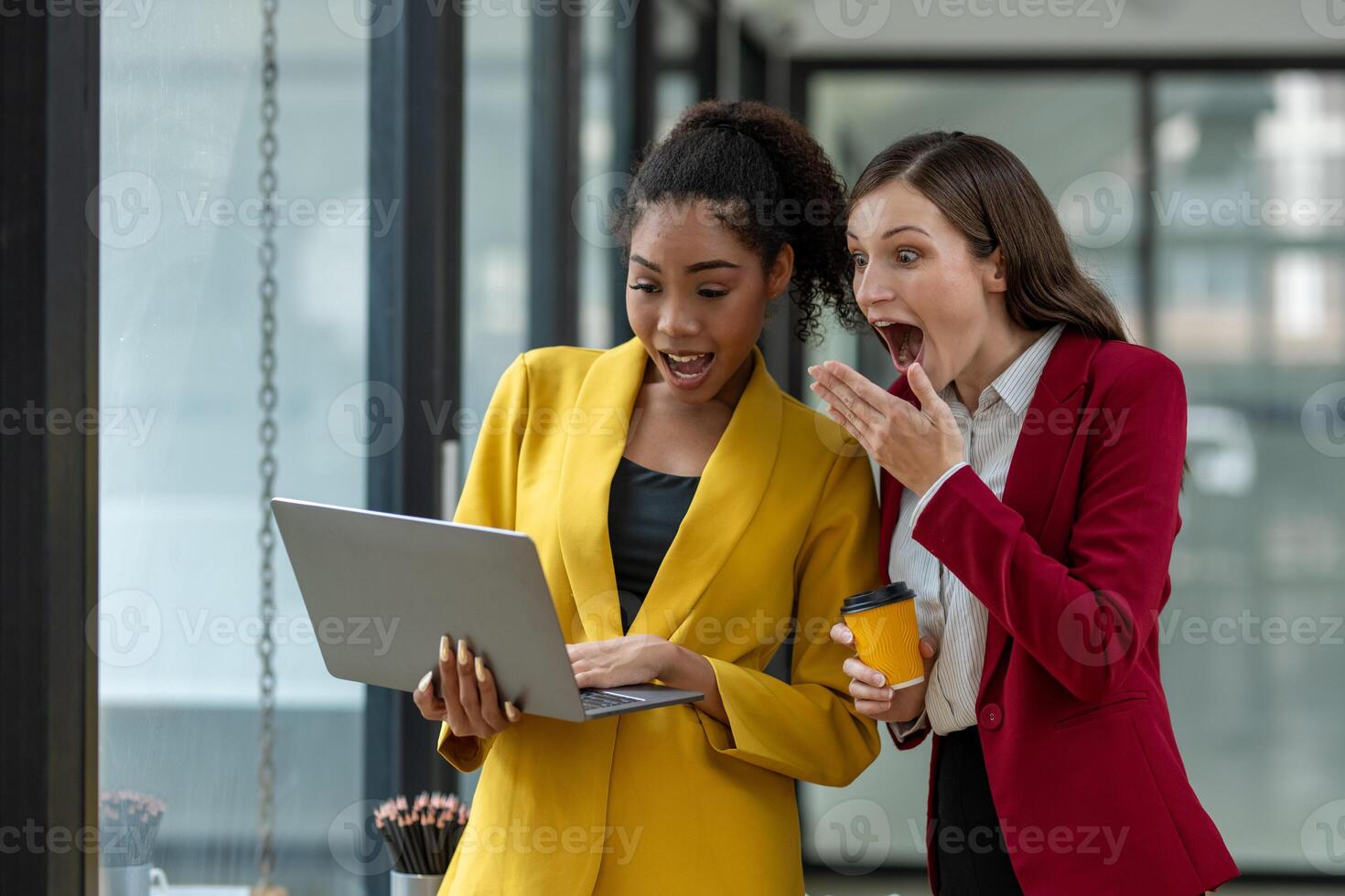 Excited business colleagues discussing over a digital tablet, sharing ideas in a dynamic office setting. photo