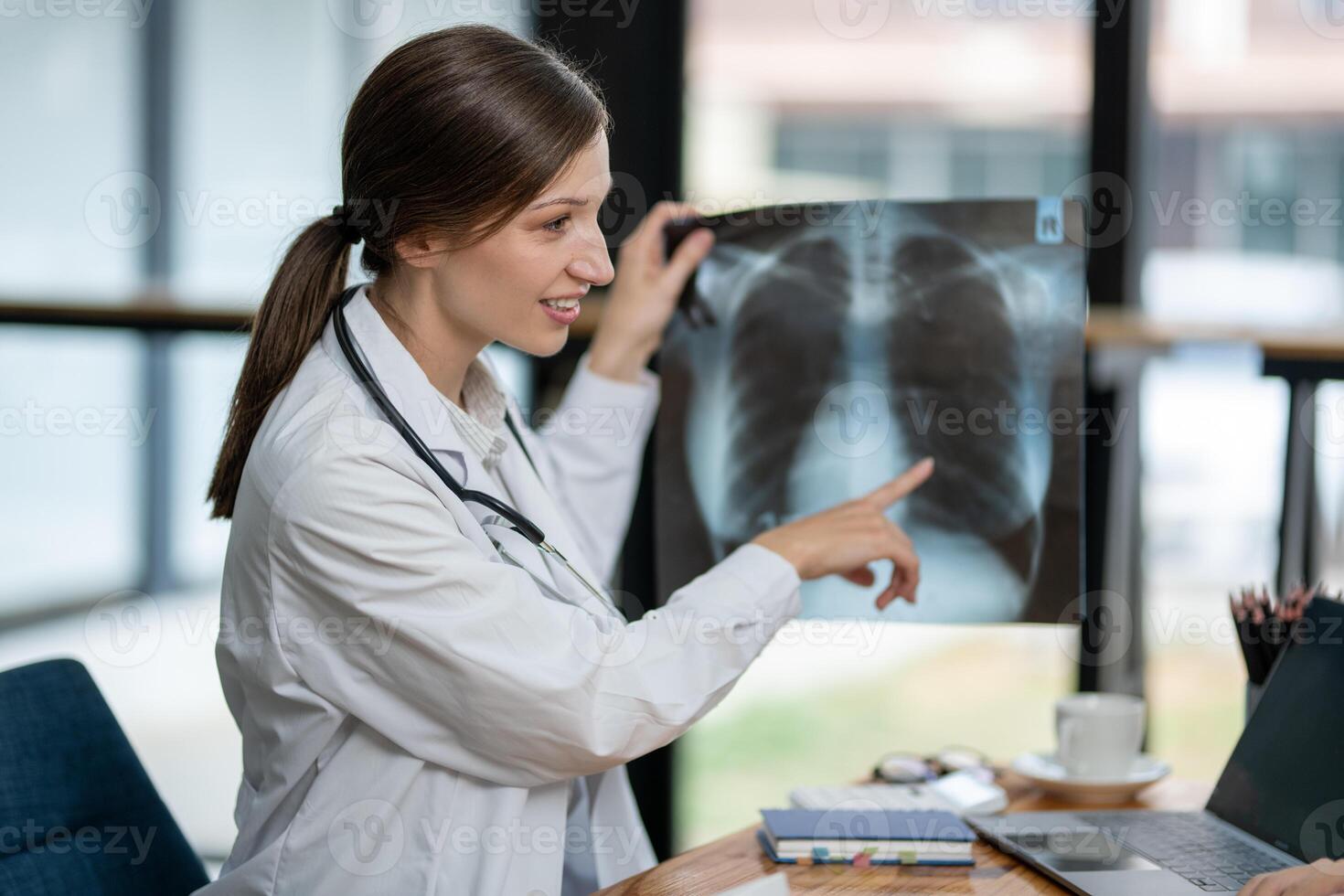 A doctor discusses chest X-ray results with her patient, explaining the health findings in a clear and supportive manner. photo
