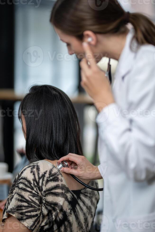 Doctor using a stethoscope checking patient with examining, presenting results symptom and recommend treatment method, Healthcare and medical concept photo