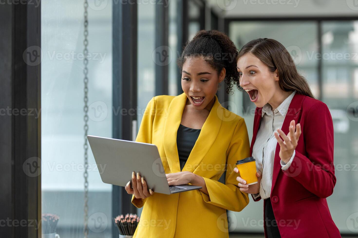 Excited business colleagues discussing over a digital tablet, sharing ideas in a dynamic office setting. photo