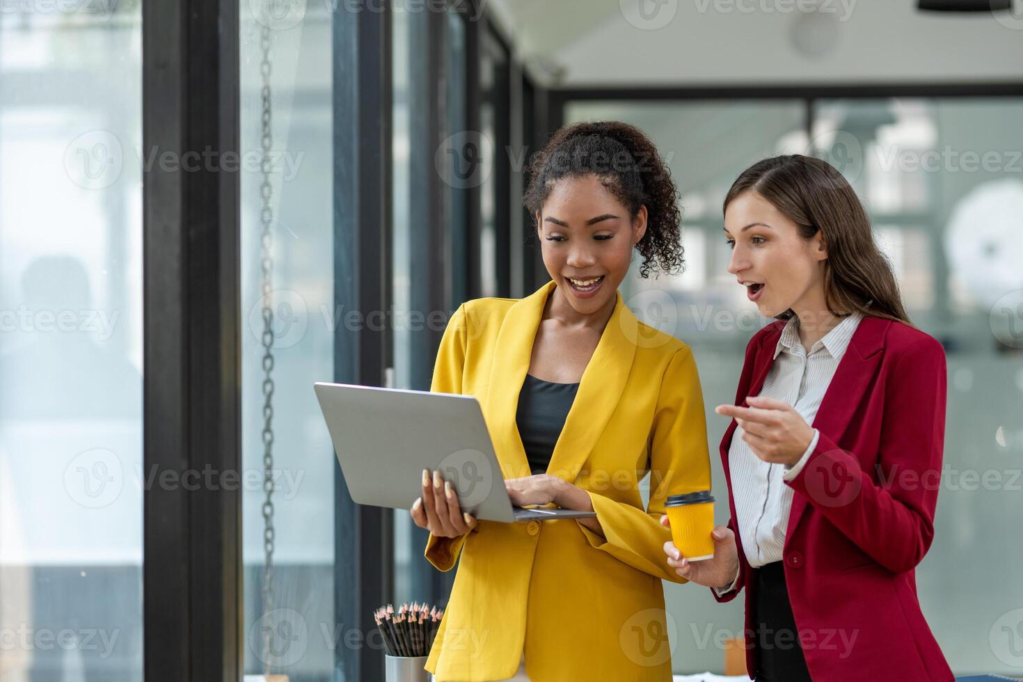 Excited business colleagues discussing over a digital tablet, sharing ideas in a dynamic office setting. photo