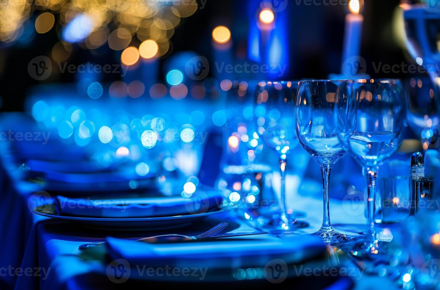 Elegant table setting glowing under blue lights in upscale restaurant photo