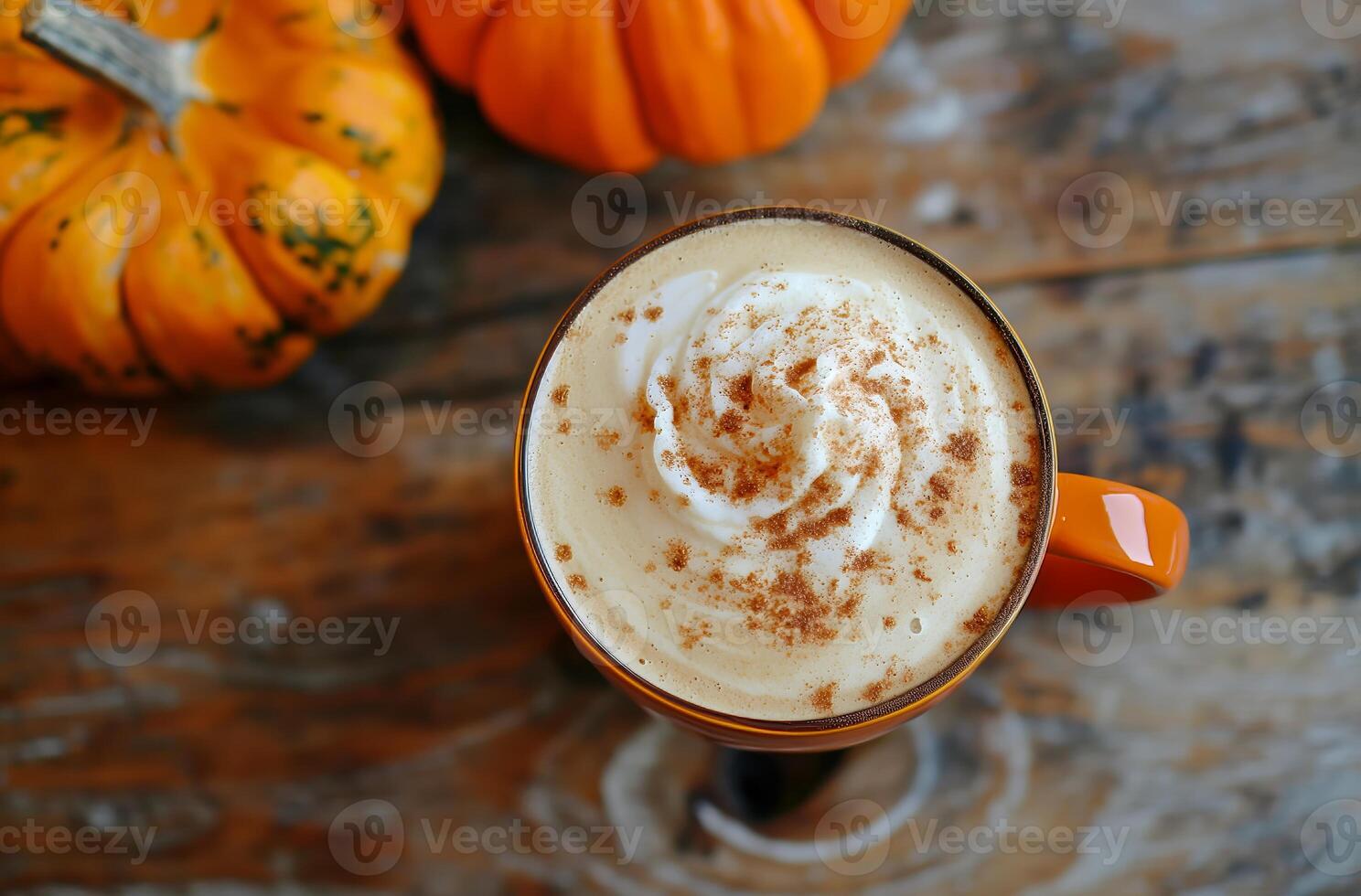 Steaming pumpkin spice latte sitting on rustic wooden table with pumpkins photo