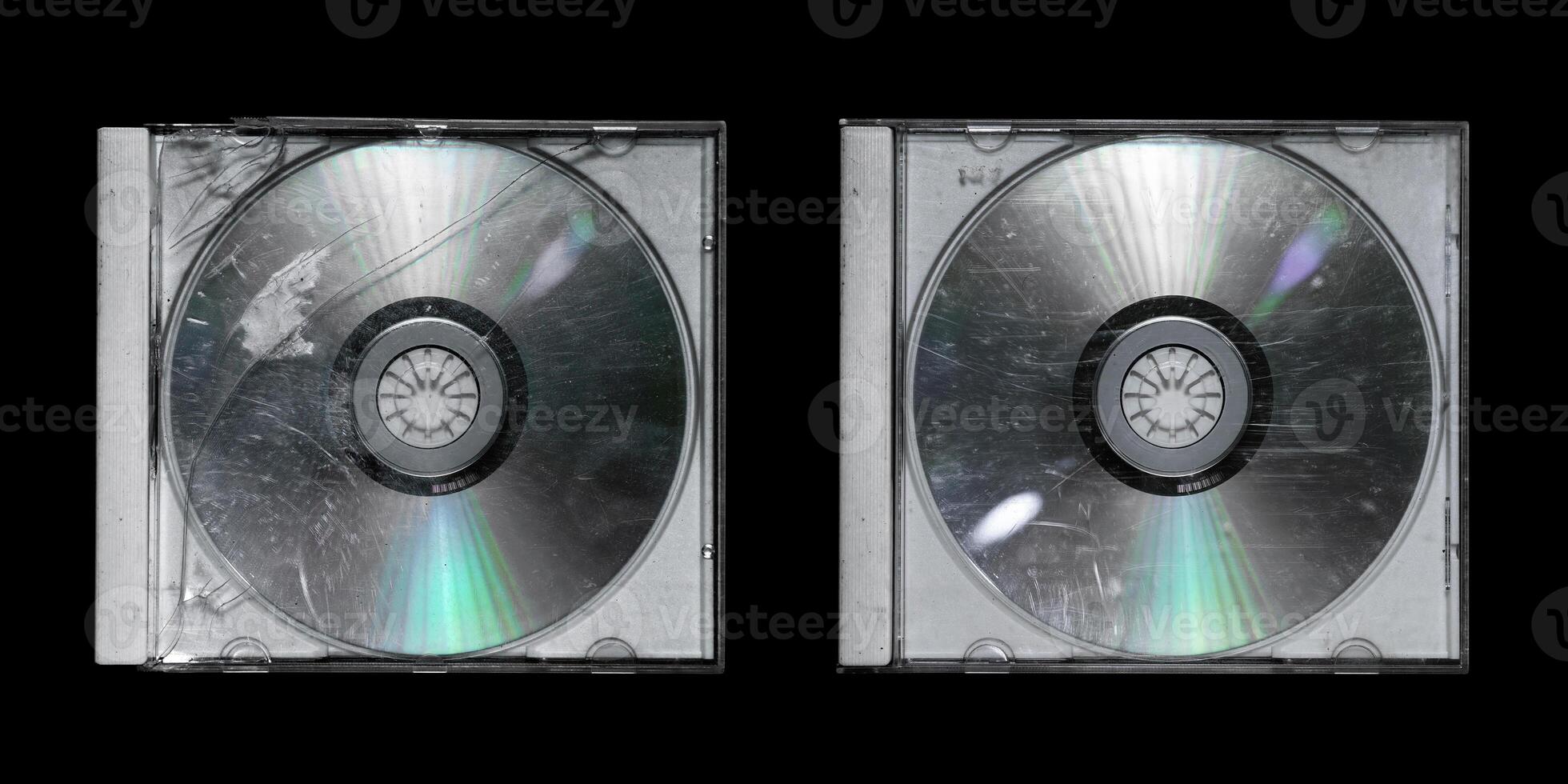Old damaged white cd case set isolated in black background photo