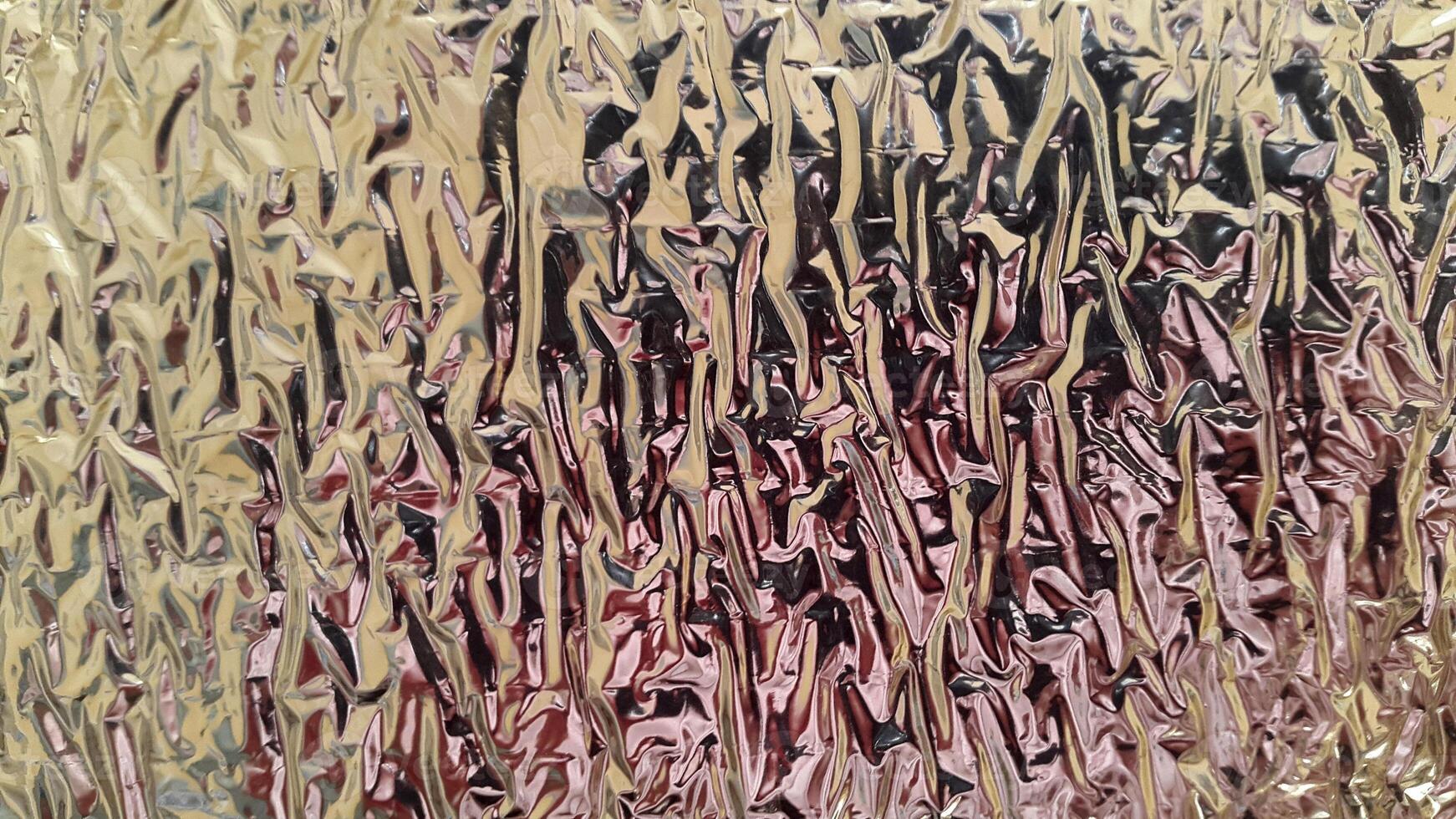 Wrinkled foil surface. Foil texture. Background with crumpled foil photo