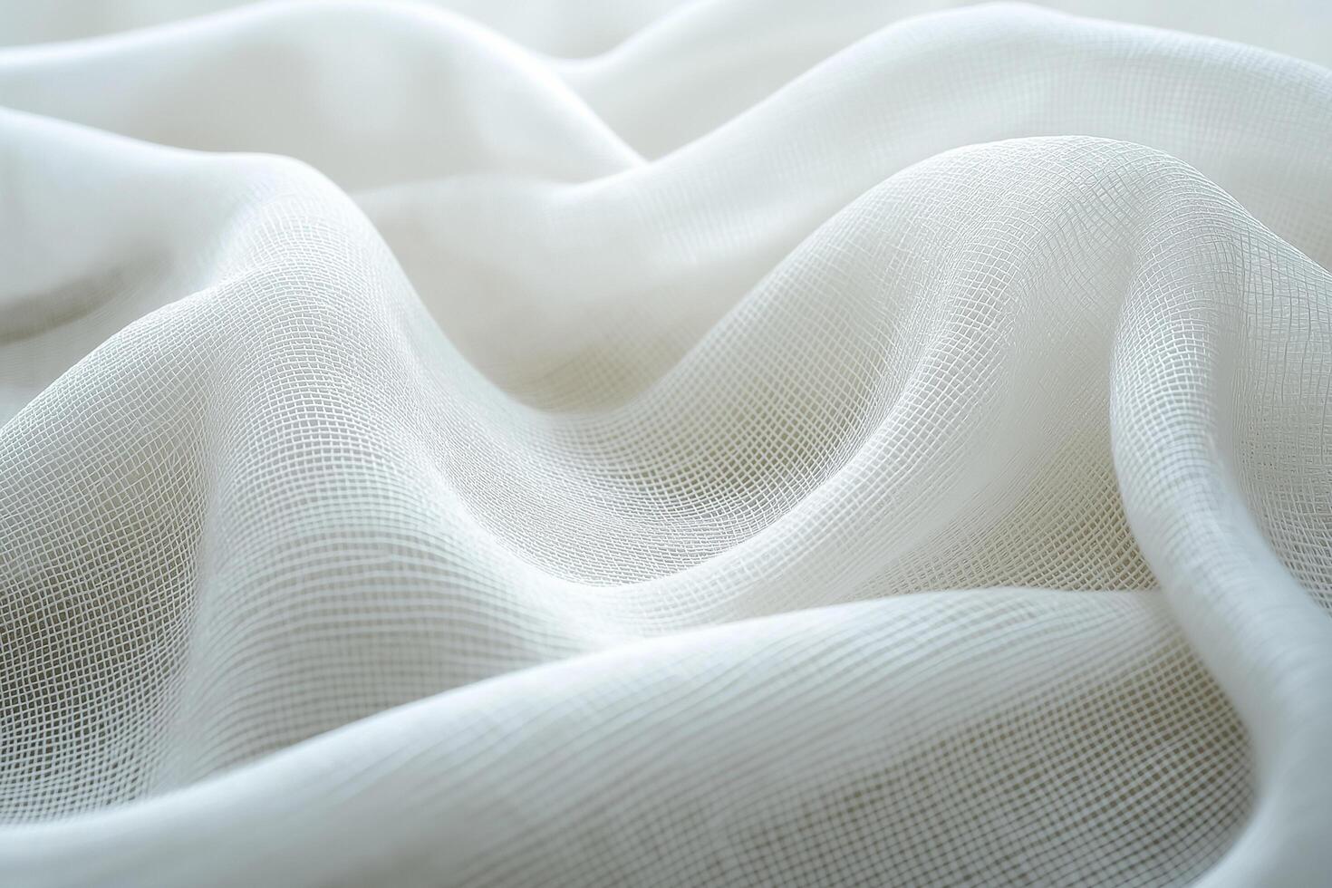 Soft, white fabric with a delicate, sheer texture, gently draped in smooth waves, creating an elegant and airy look photo