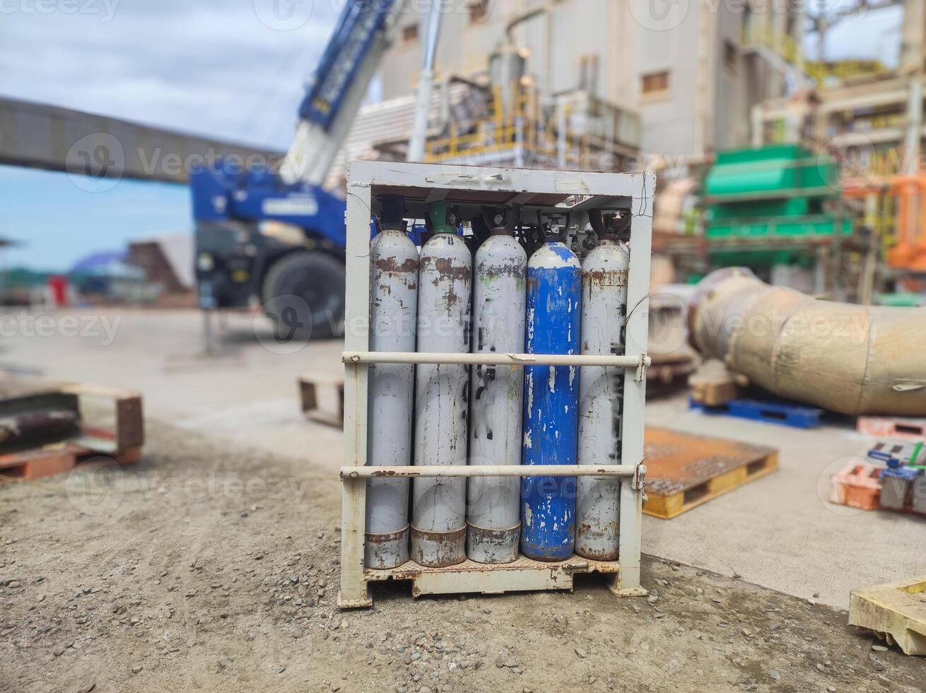 high pressure argon cylinder bottles inside the basket rack. concept illustration of safe storage of tubes in factory industrial area. photo