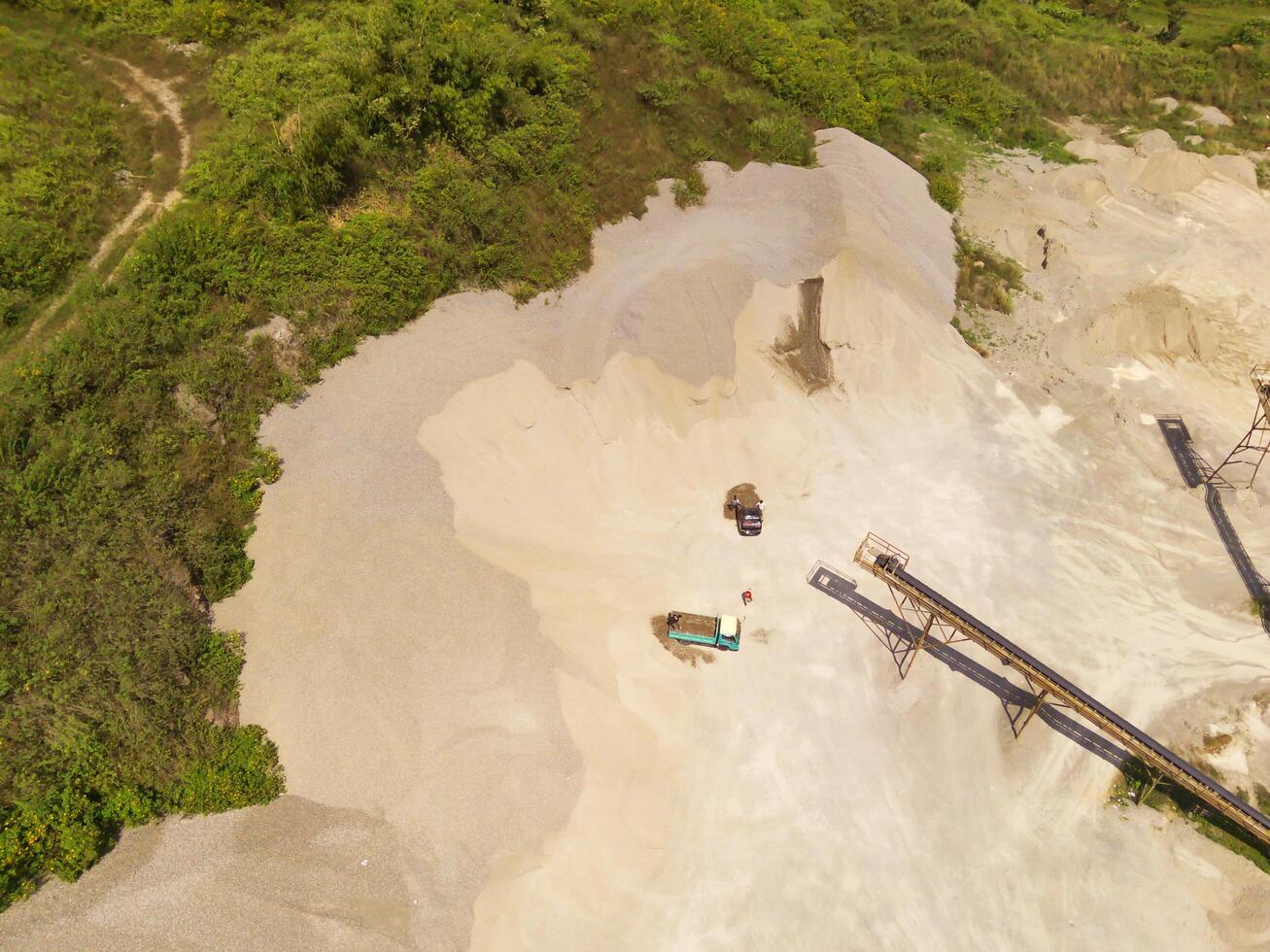 Landscape of truck and conveyor belt in the middle of sand pit. Mining Industry. Panoramic Landscape. Mining material transportation. Sand and stone mining. Drone Photography. Aerial Photography photo