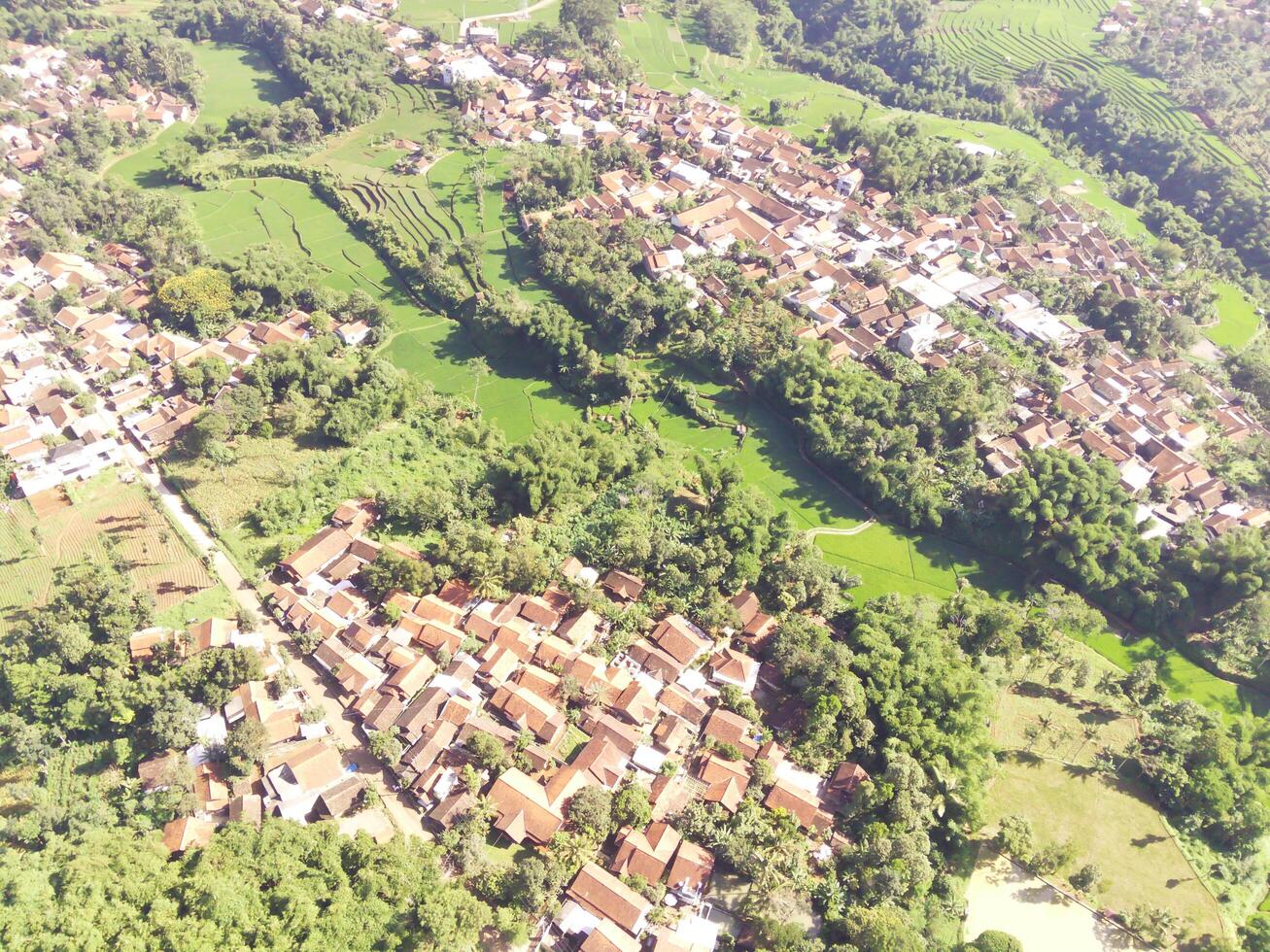 Beautiful 4K drone photography of a dense village in a valley. Housing Industry. Panoramic Landscape. Graphic Resources. Social Issues. Aerial Landscape Photography Concept photo