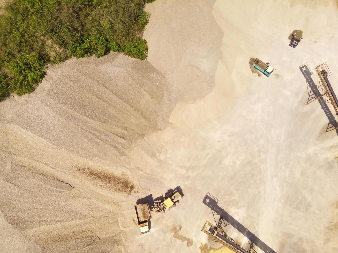 Landscape of truck and conveyor belt in the middle of sand pit. Mining Industry. Panoramic Landscape. Mining material transportation. Sand and stone mining. Drone Photography. Aerial Photography photo