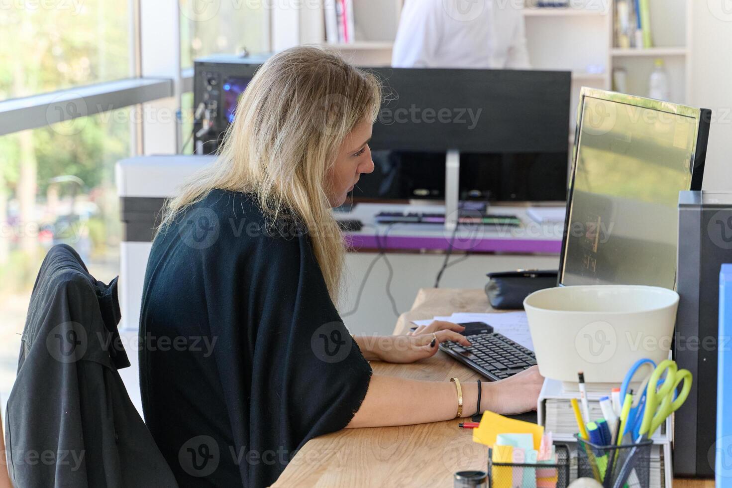 Businesswoman Programming a Product Design for Wood Processing Machine in Modern Office photo