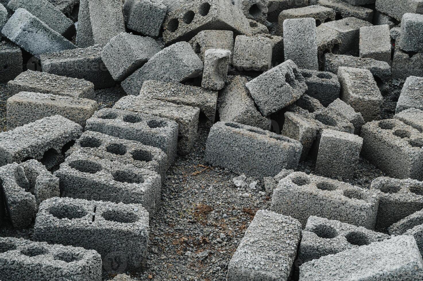 a pile of cinder blocks made of gray concrete, a material for building a house photo