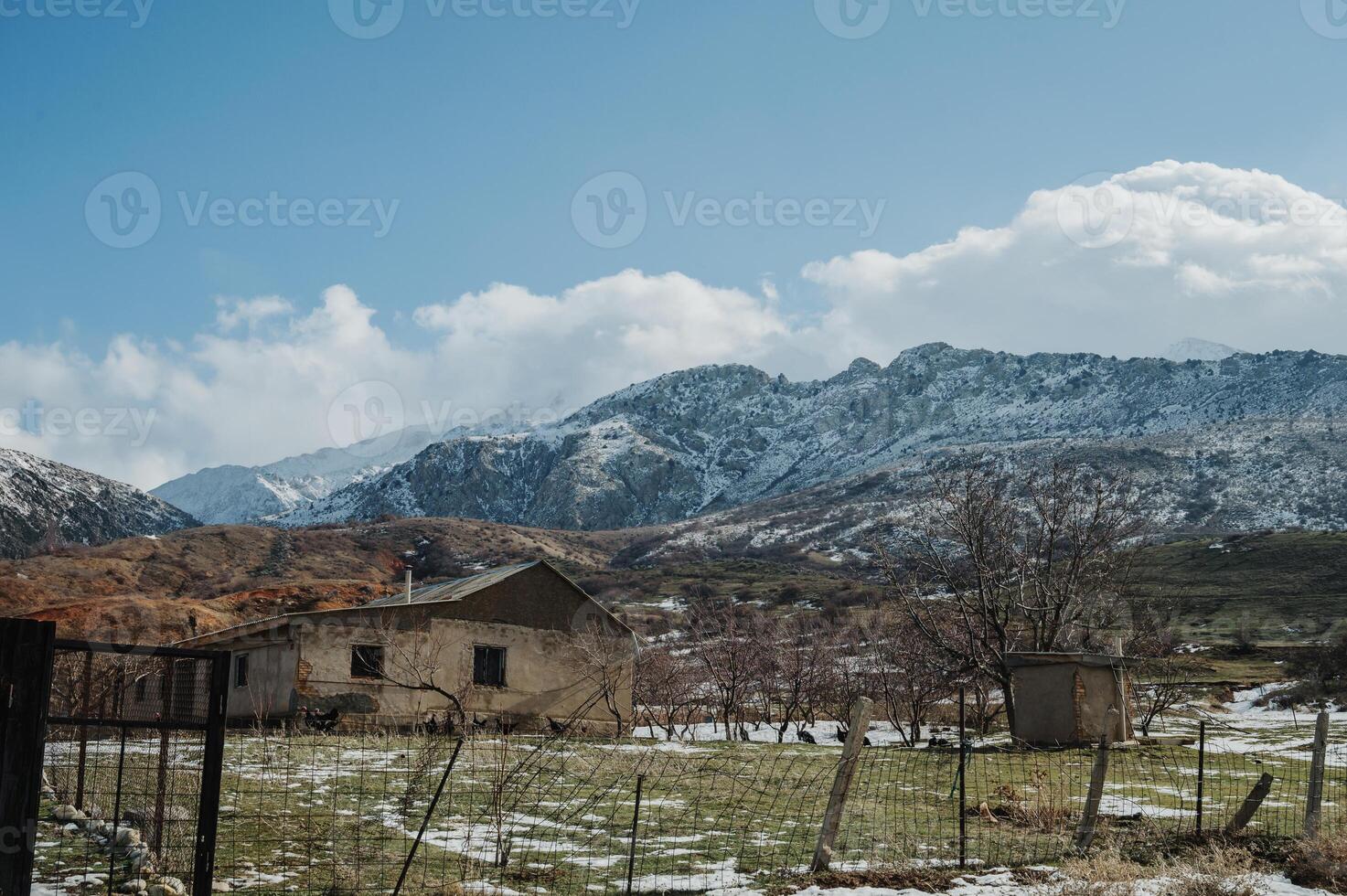 Panoramic view of the snow-capped mountains with huts photo
