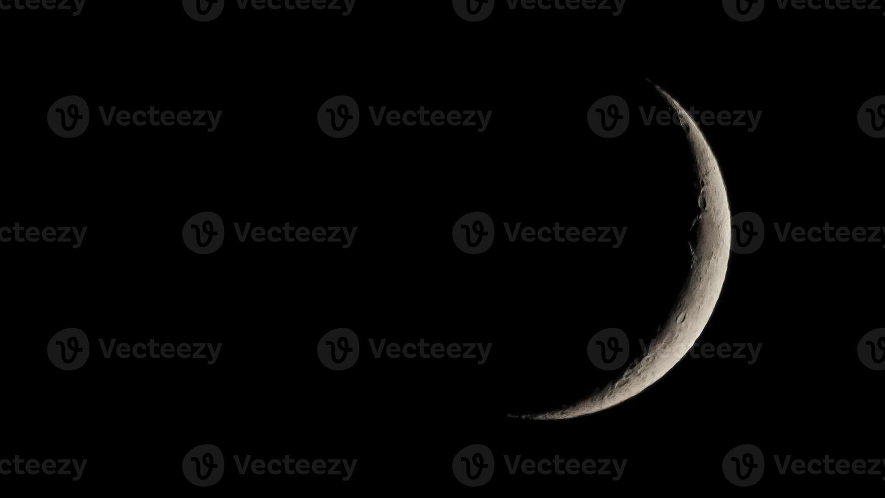 Waxing crescent moon seen with telescope photo