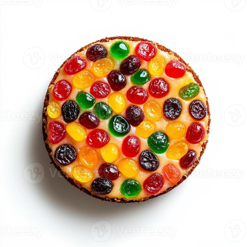 Christmas fruitcake with colorful candied fruits, isolated on white background, top view photo