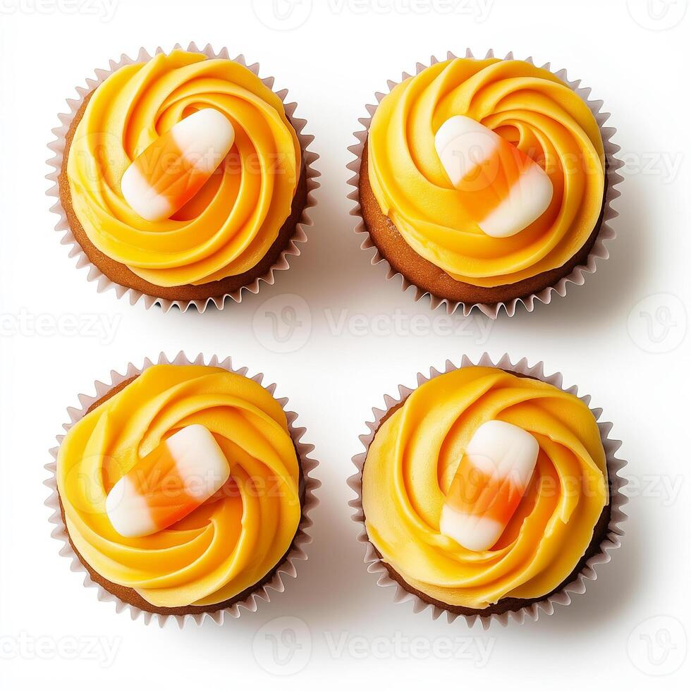 Halloween candy corn cupcakes with orange frosting and candy corn decorations, isolated on white background, top view photo