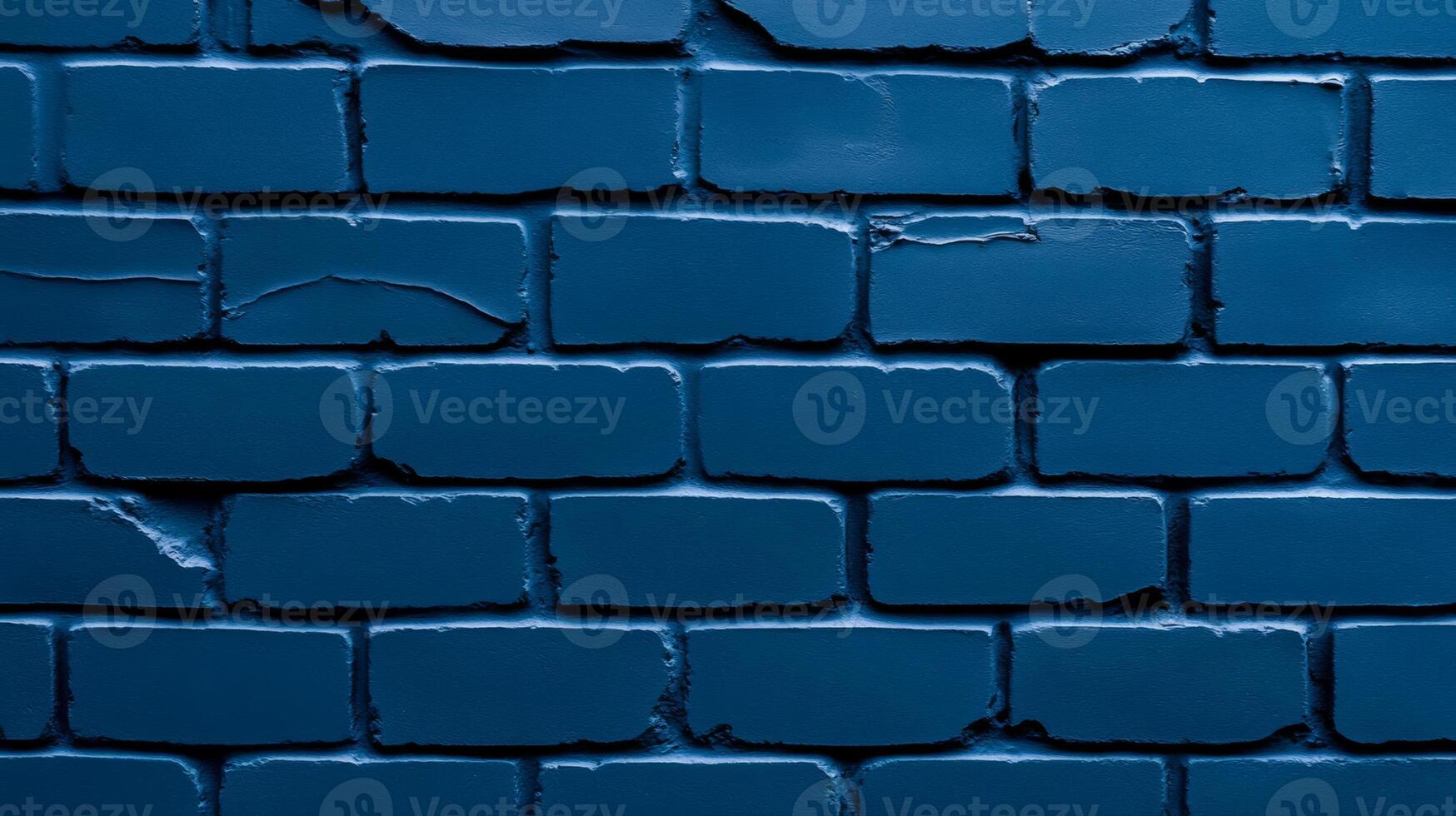 Macro view of a painted brick wall in deep navy blue textured surface with visible cracks and weathering for a moody and dramatic urban background photo