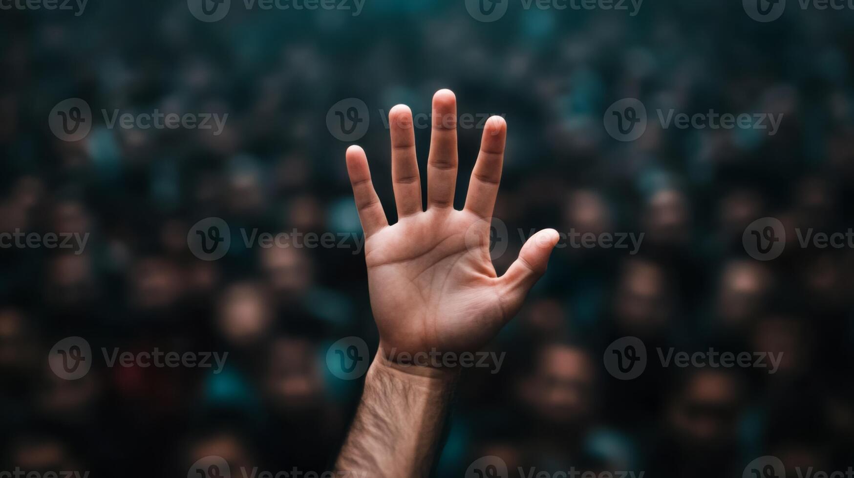 Closeup of a persons hand reaching out desperately through a thick crowd the crowd blurred to highlight the sense of urgency photo
