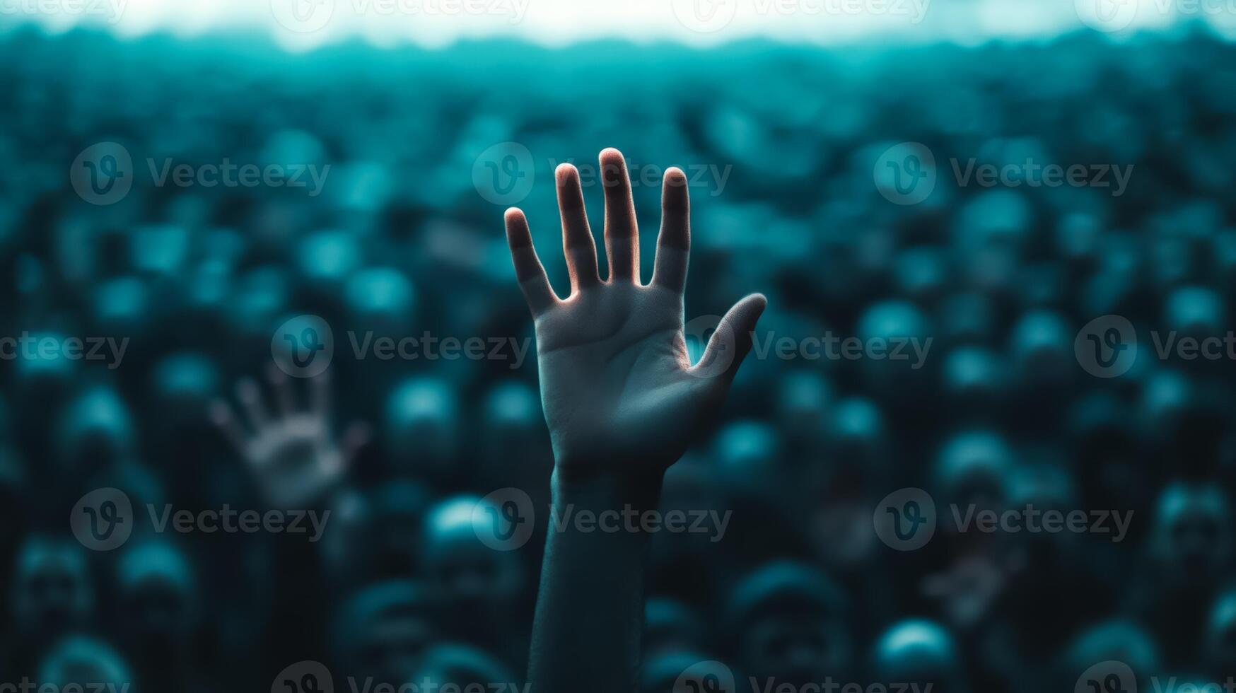 Closeup of a persons hand reaching out desperately through a thick crowd the crowd blurred to highlight the sense of urgency photo