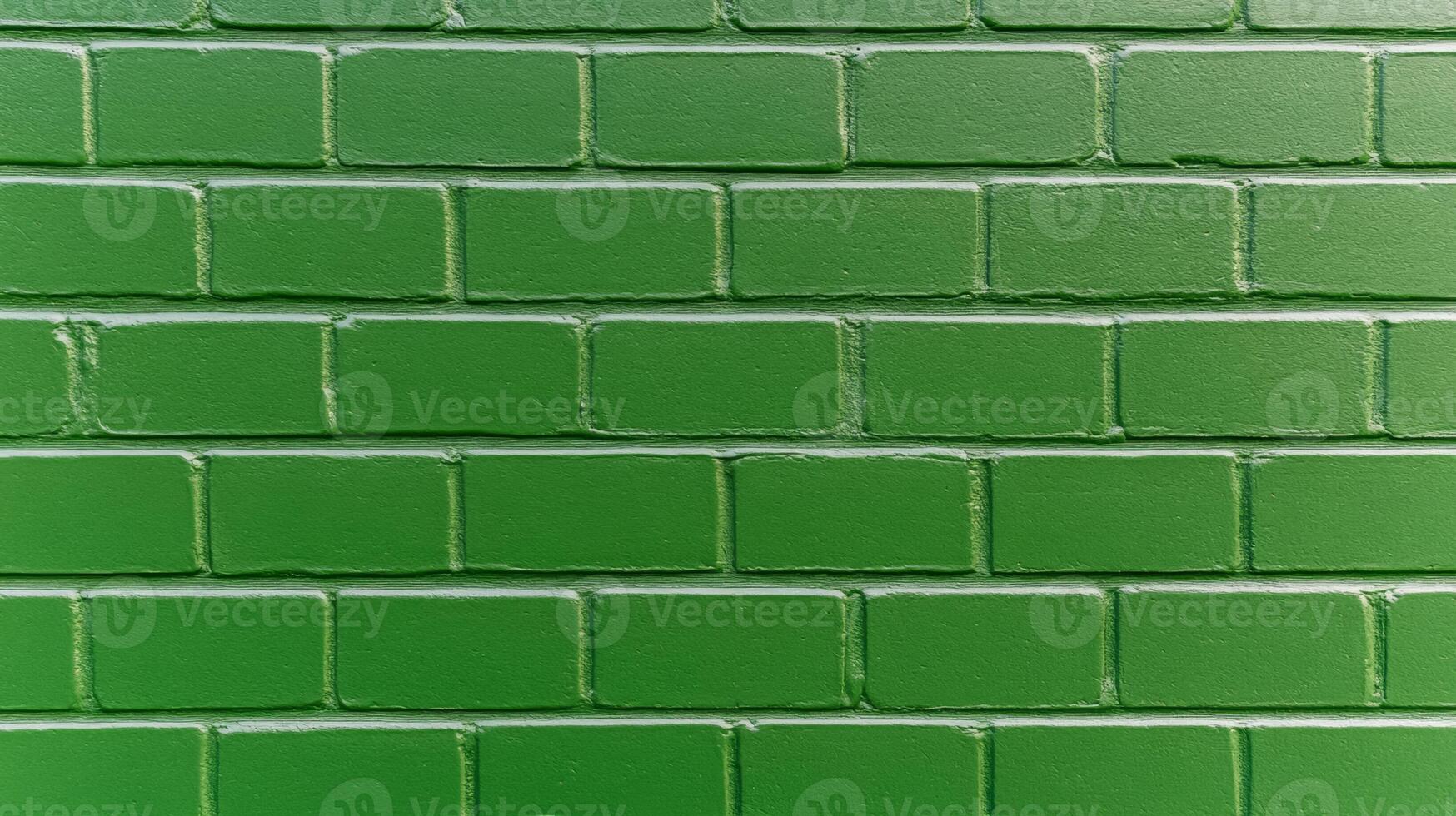 Front view of a brick wall painted in forest green texture with visible brush strokes and slight discoloration creating a natural and organic atmosphere photo