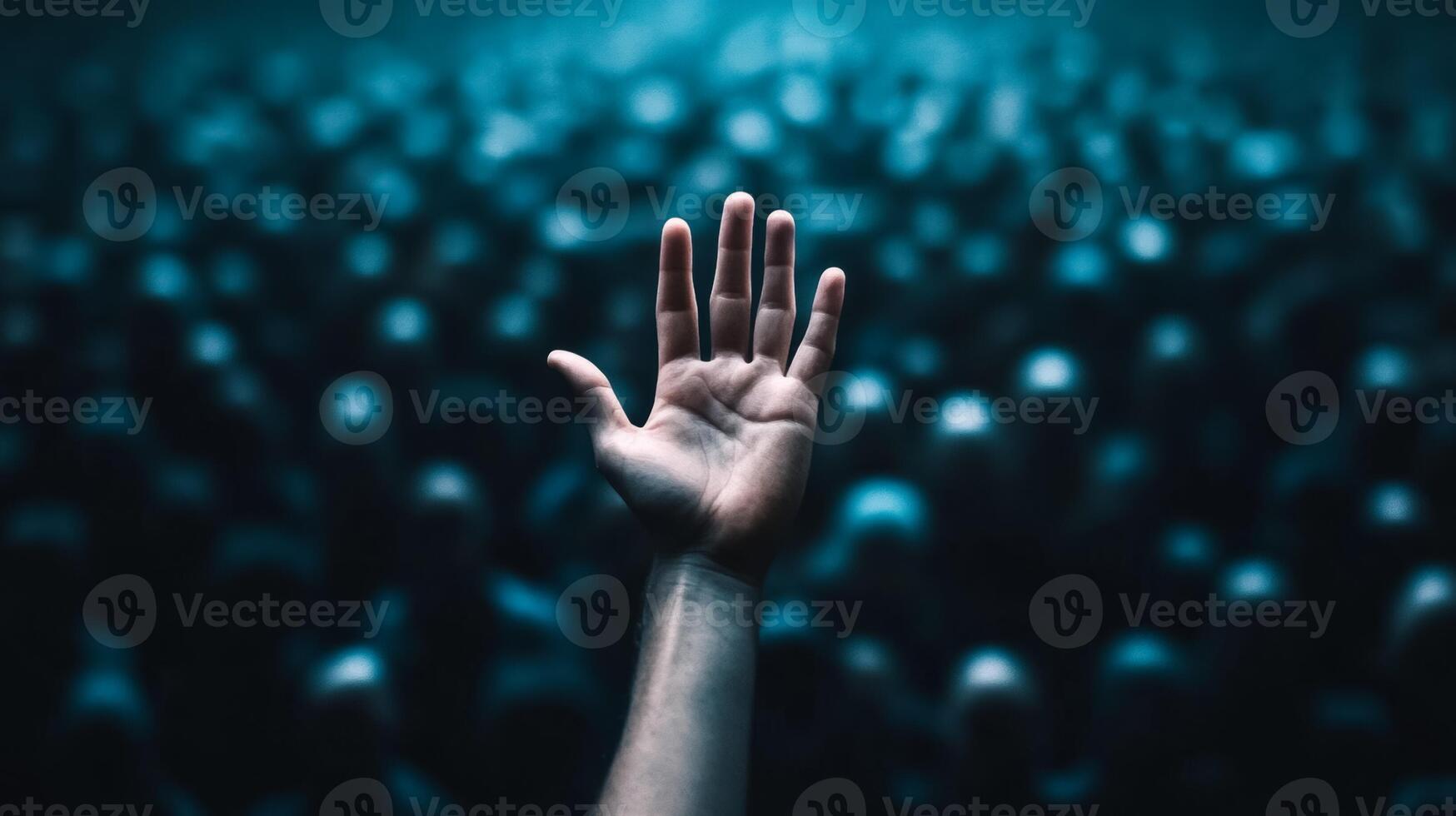 Closeup of a persons hand reaching out desperately through a thick crowd the crowd blurred to highlight the sense of urgency photo