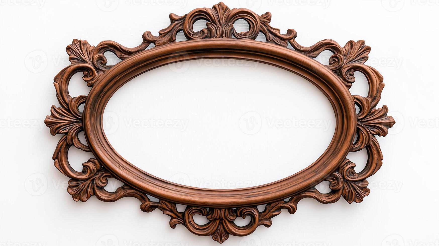 Wide angle shot of a vintage oval shaped picture frame with elaborate carvings and patina featuring baroque style scrolls and leaves isolated on a pure white background photo
