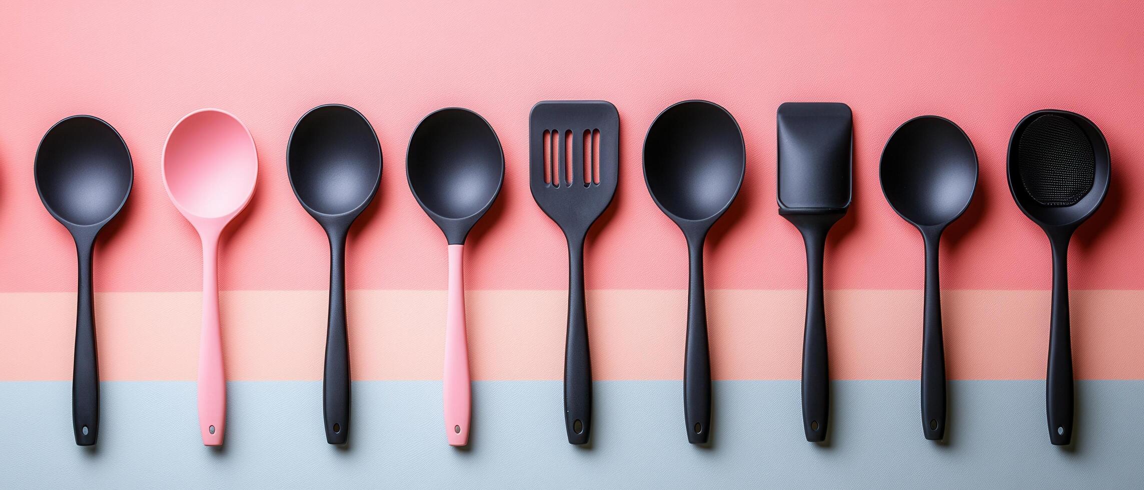 Modern Kitchen Utensils Set on Colorful Background - Black and Pink Cooking Tools in a Row photo