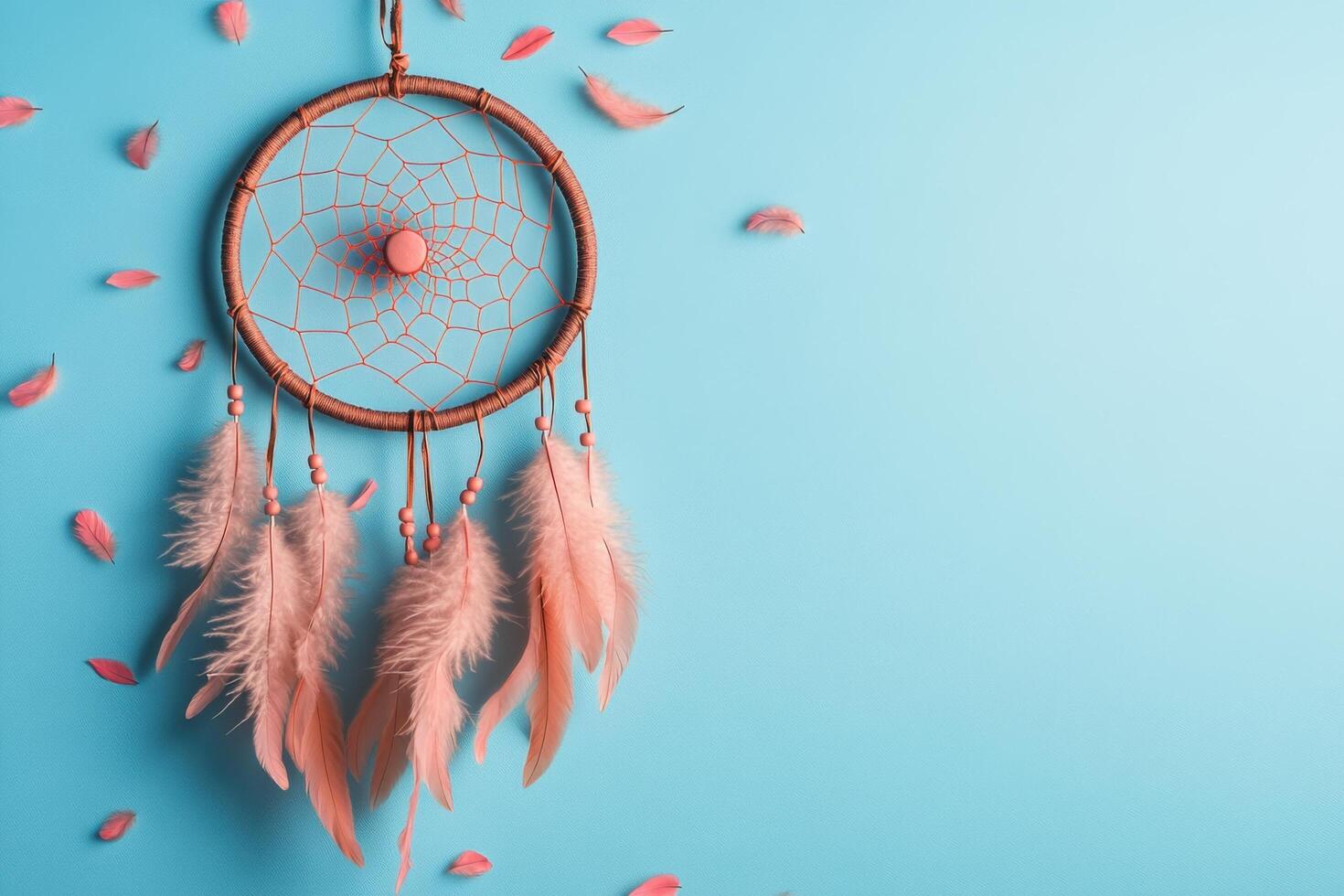 Handcrafted Dreamcatcher with Pink Feathers on Blue Background - Bohemian Decor and Native American Symbolism photo