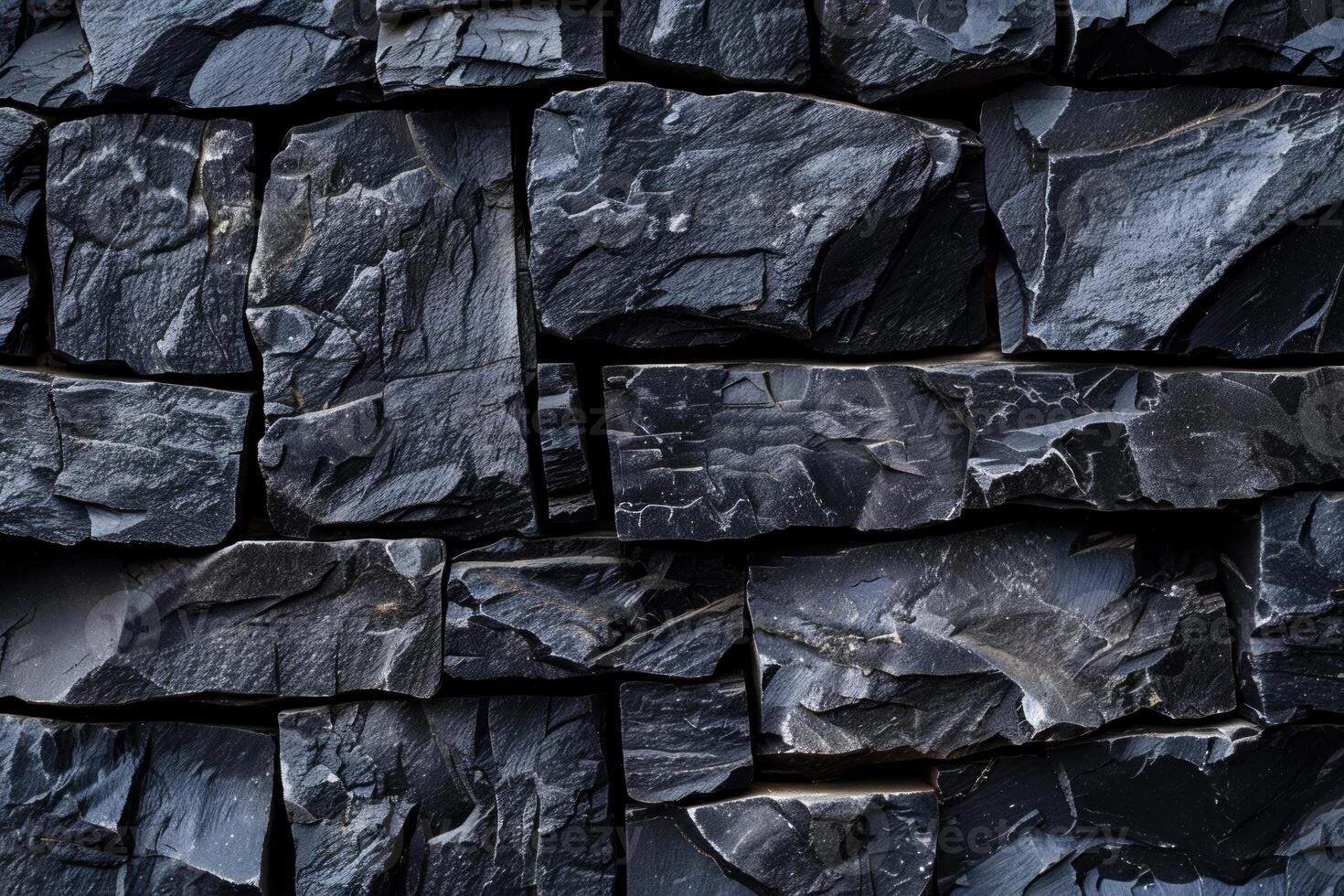 Dark grey stone wall texture background showing rough surface of natural material forming pattern photo