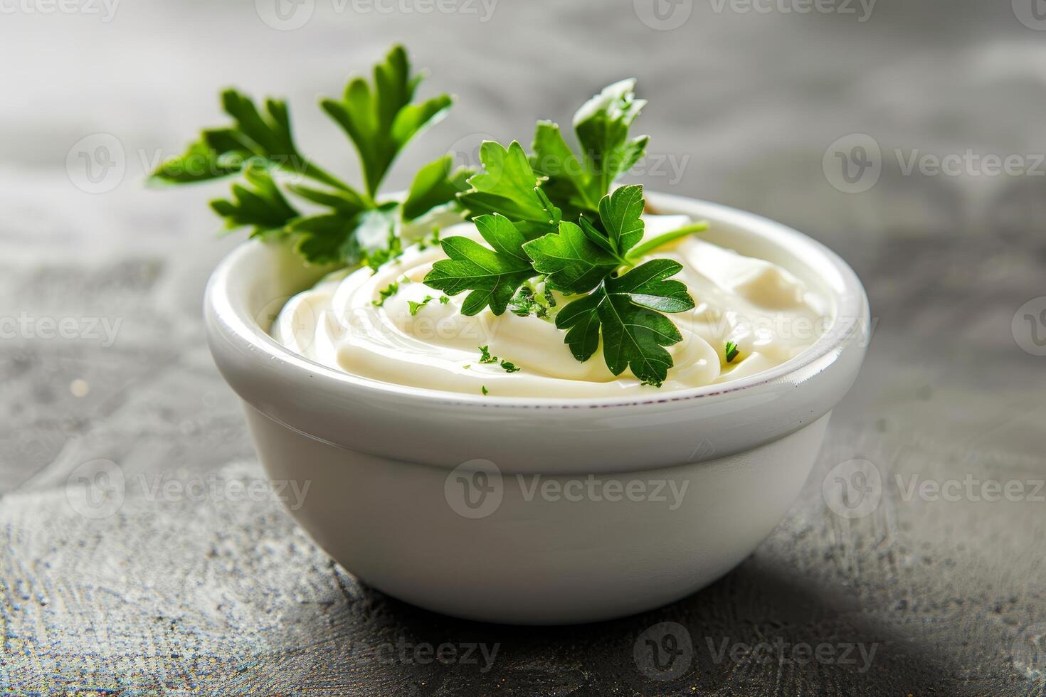 Bowl of mayonnaise sauce with parsley on dark background photo