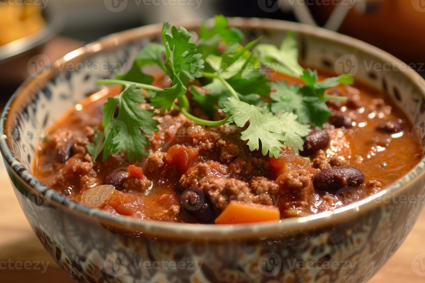 Close up on a bowl of spicy chili garnished with fresh cilantro photo