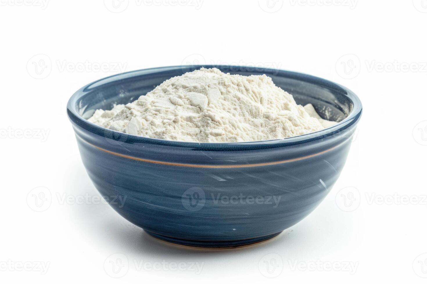 Blue bowl overflowing with white flour on white background photo
