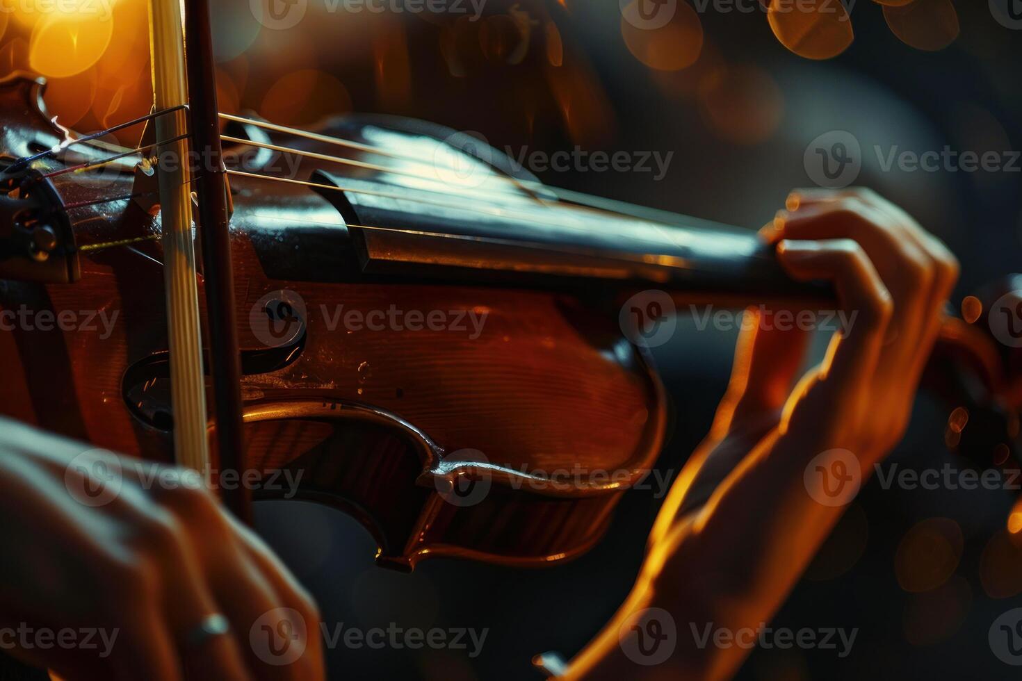Musician playing violin with bow on stage with blurred lights photo