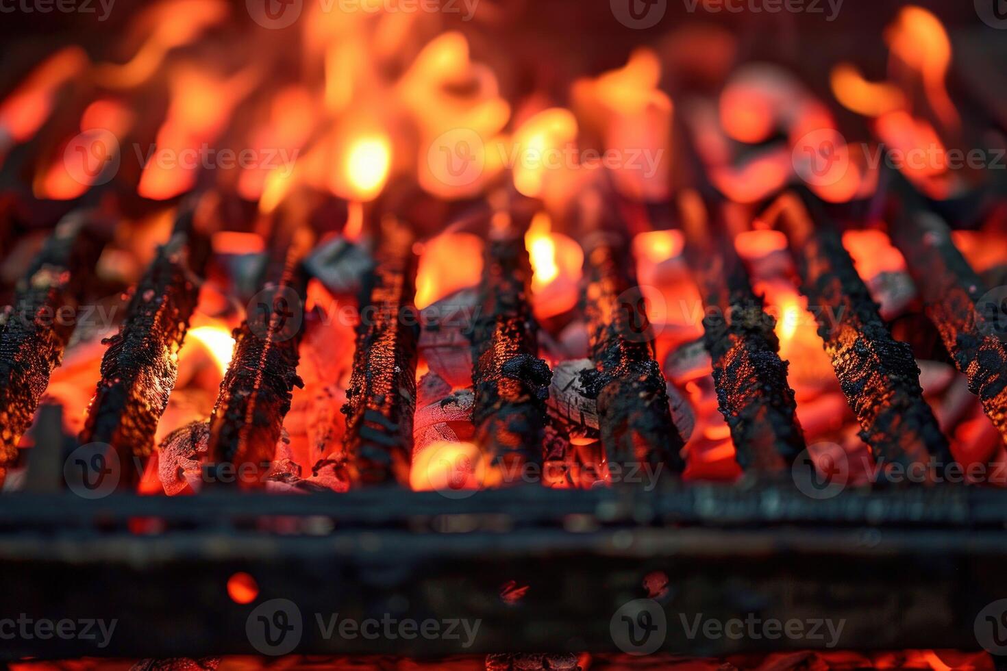 Burning charcoal briquettes glowing red on a hot grill photo
