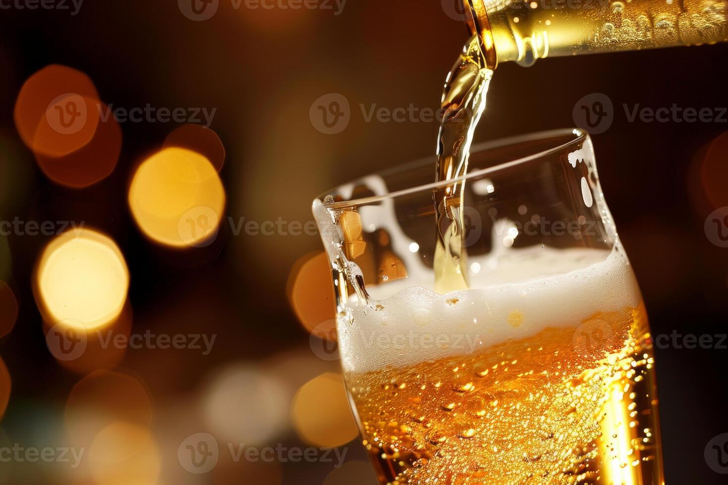 Bartender is pouring a cold beer from a bottle into a glass in a bar photo