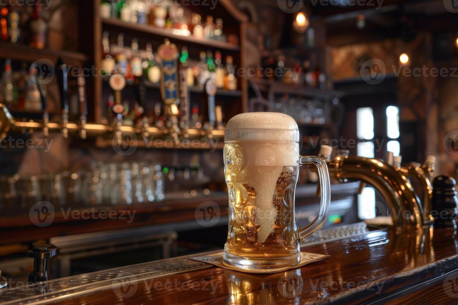 Refreshing glass of beer with foam is waiting on the counter for the customer photo