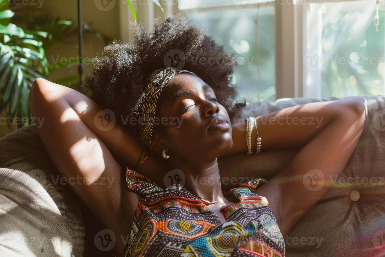 Young black woman relaxing at home on the couch photo