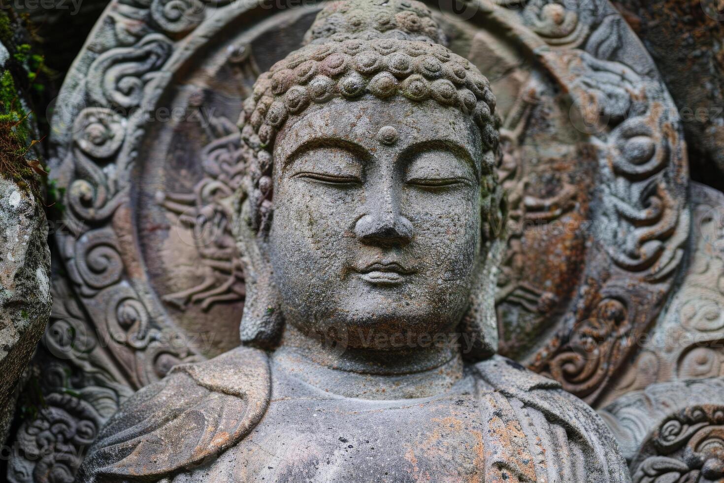 Ancient stone buddha statue meditating with eyes closed photo