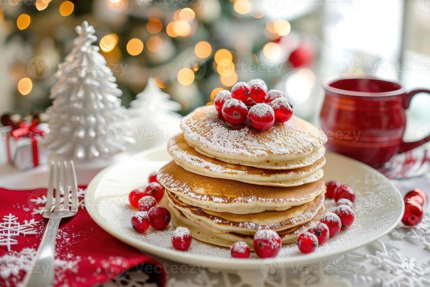 Christmas breakfast with delicious pancakes topped with red currants and icing sugar photo
