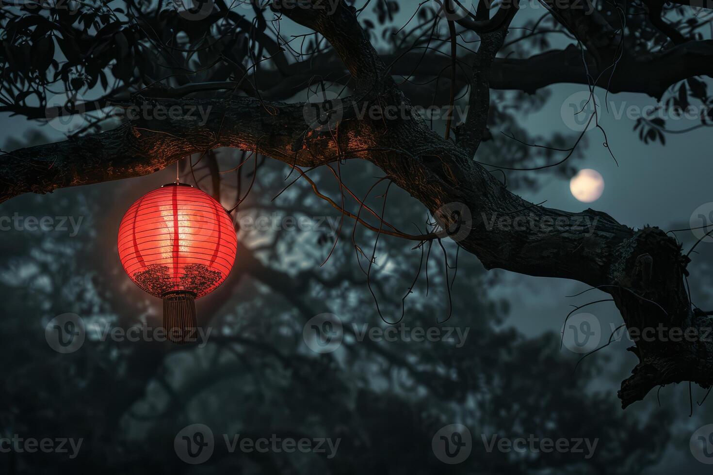 Enigmatic red lantern illuminating tree at dusk photo
