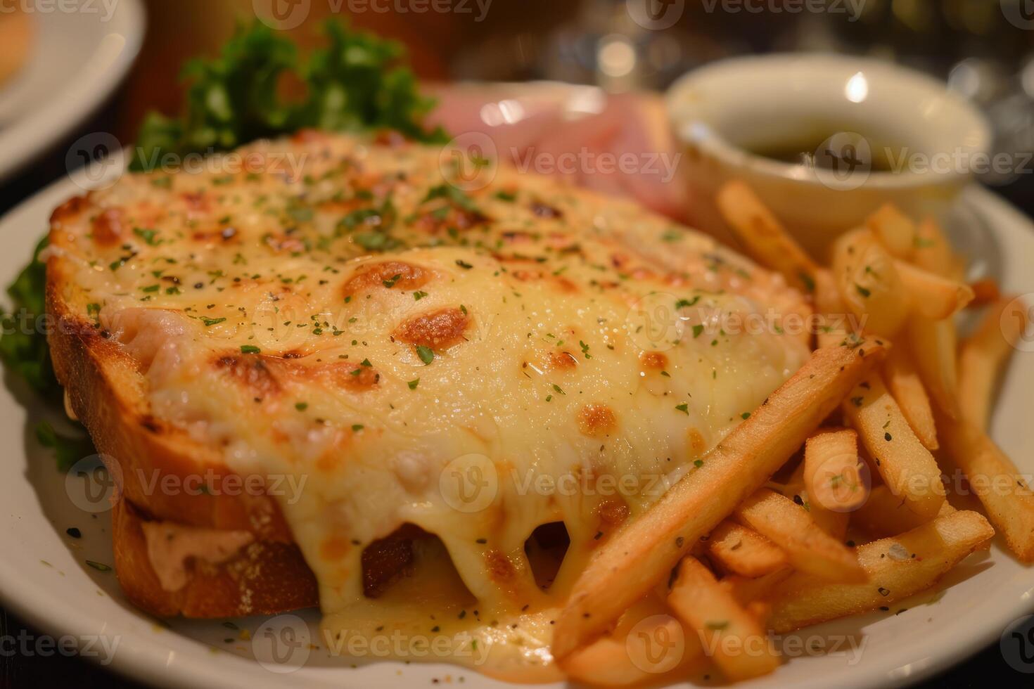 Cheesy croque monsieur with french fries and dipping sauce photo