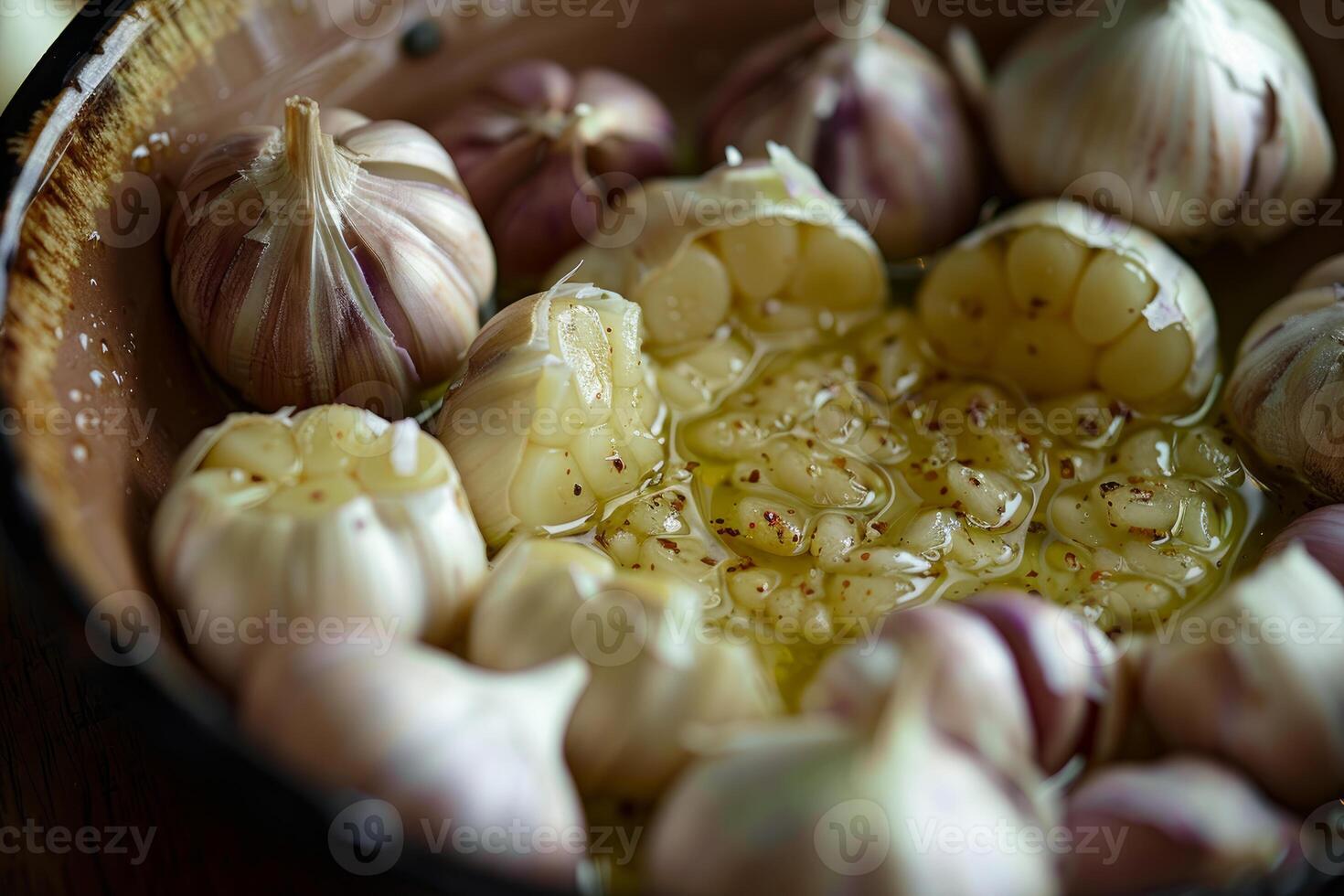 Fresh garlic cloves soaking in olive oil photo