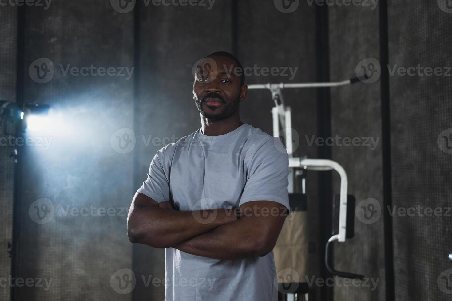 Fitness workout in gym. Portrait of African American man standing in gym with motivation health energy ready for training. Athletic coach personal trainer fitness club owner. Healthy lifestyle photo