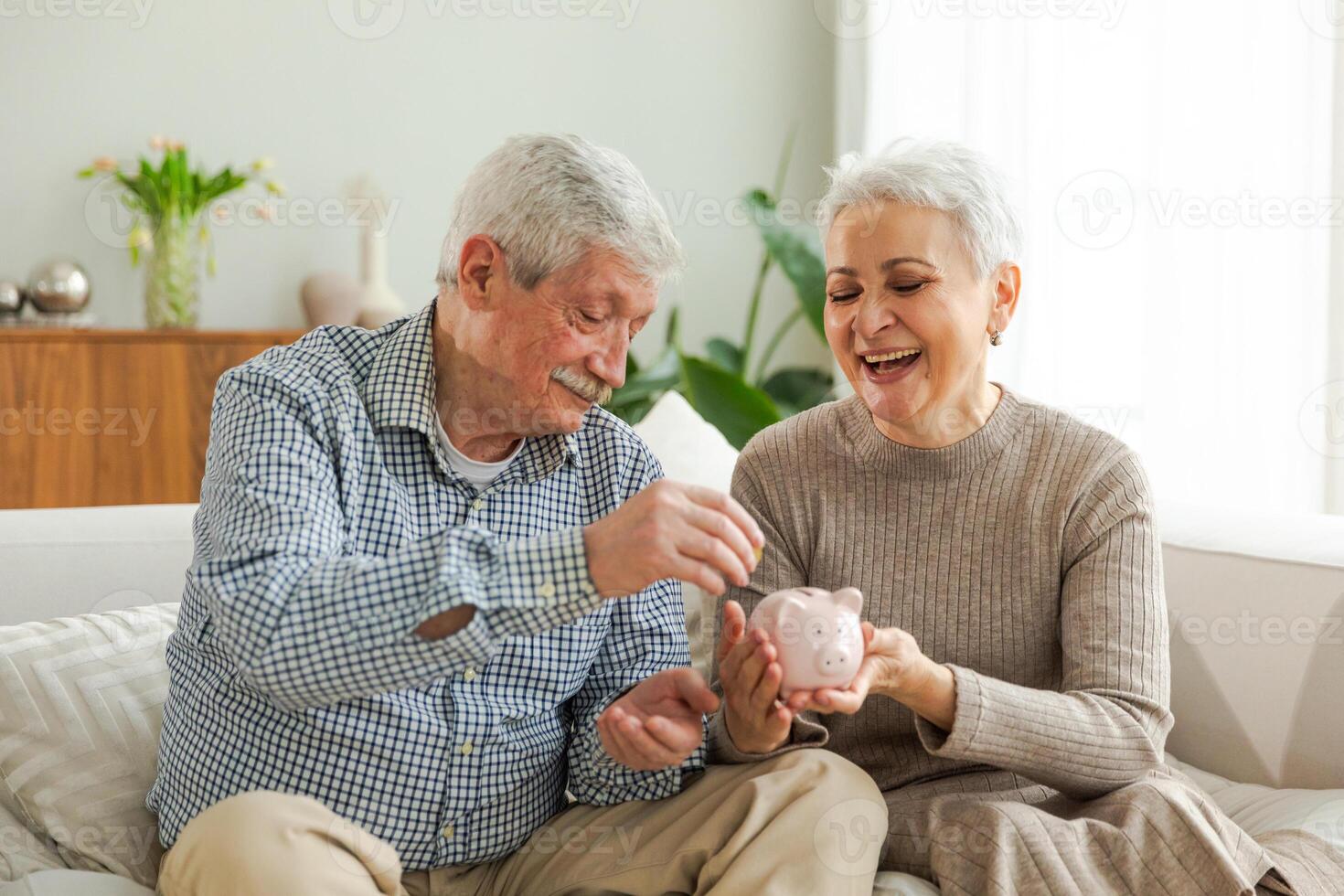 Saving money investment for future. Senior adult mature couple holding piggy bank putting money coin. Old man woman counting saving money planning retirement budget. Saving investment banking concept photo