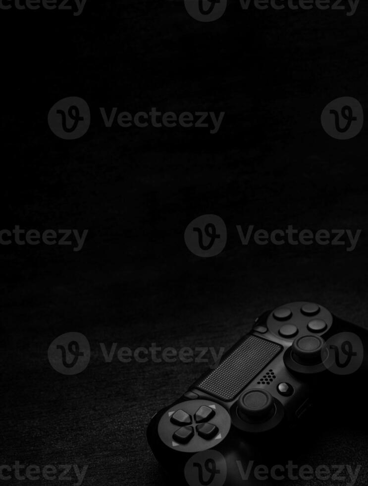 black wireless gamepad on a black background photo