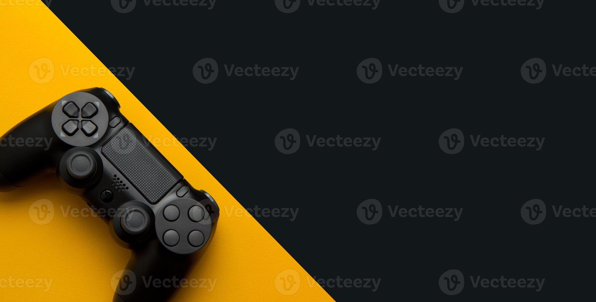 black wireless gamepad on a black and yellow background photo