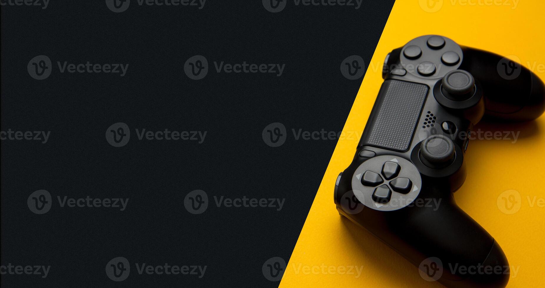 black wireless gamepad on a black and yellow background photo