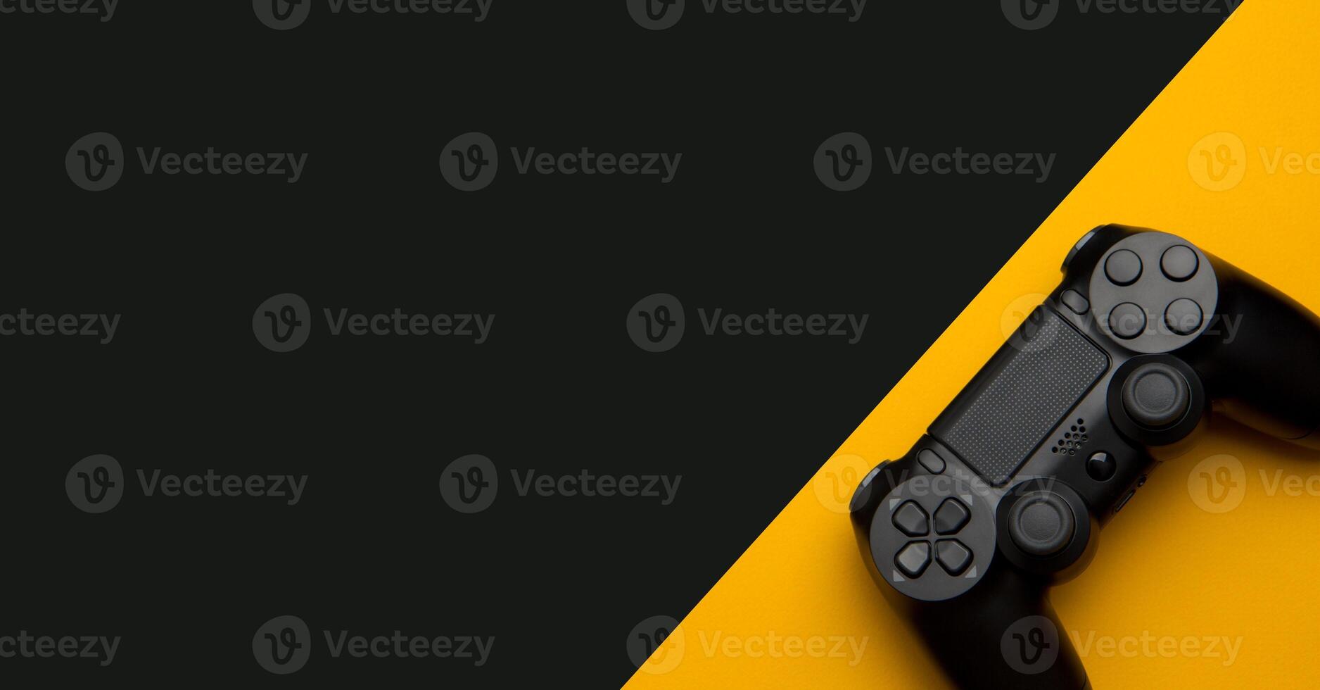 black wireless gamepad on a black and yellow background photo