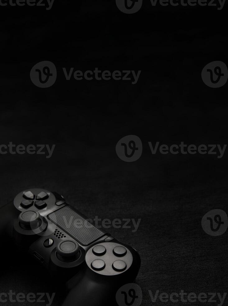 black wireless gamepad on a black background photo