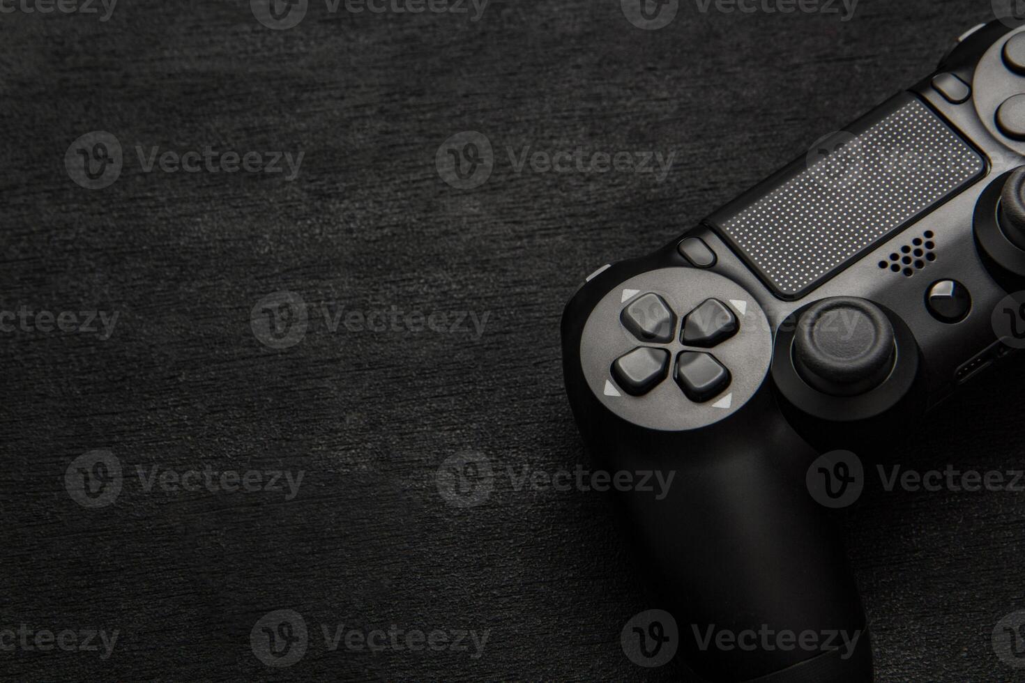 black wireless gamepad on a black background photo